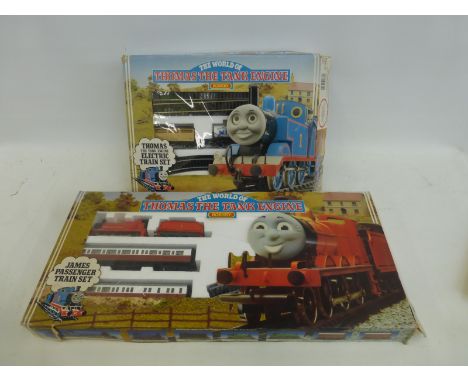 A boxed Hornby 00 gauge Thomas The Tank Engine electric train set and a James passenger train set.
