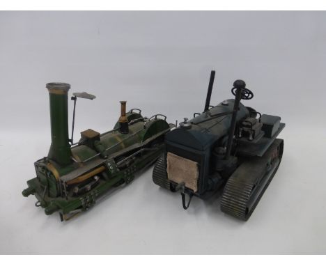 A tinplate model of a caterpillar tractor and a steam engine.