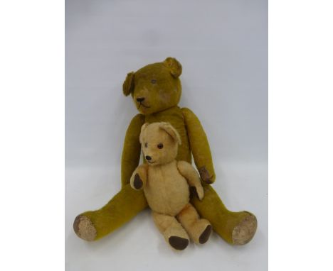 A large jointed teddy bear with leather pads to hands and feet and one other smaller jointed teddy bear.