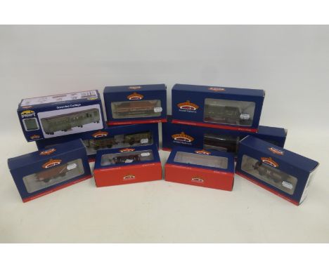 An assortment of Bachmann 00 gauge rolling stock, vans, carriages, trucks etc. all boxed and in mint condition (one van missi
