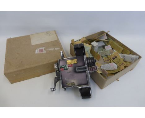 A Setright bus ticket machine and a quantity of tickets.