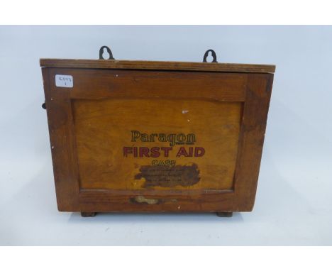 A WWII circa 1943 Paragon wall mounted wooden cased fall front first aid box (with instructions and some contents).