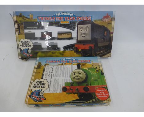 A boxed Hornby 00 gauge Thomas The Tank Engine Percy electric train set and a Devious Diesel train set.