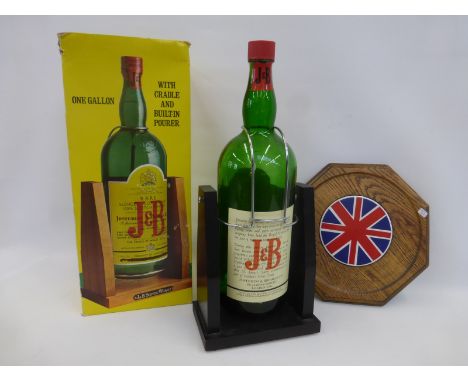 A one gallon J. & B. Scotch whisky bottle with cradle and an oak octagonal tray inset with a circular Union Jack tile.