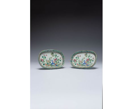 A RARE PAIR OF CHINESE FAMILLE ROSE OVAL DISHES QIANLONG 1736-95 Each painted with leafy peony branches and rockwork, encircl
