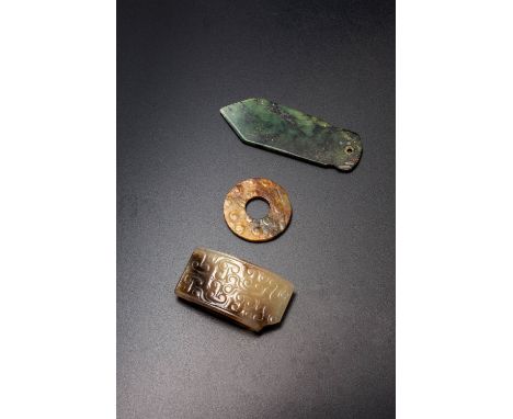 THREE SMALL CHINESE ARCHAIC JADES SHANG DYNASTY, WARRING STATES PERIOD AND HAN DYNASTY One a spinach-green dagger-shaped axe,