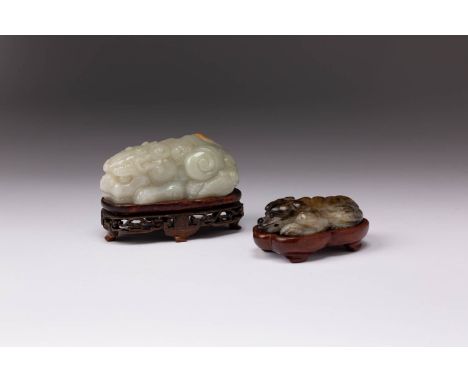 TWO CHINESE JADE CARVINGS OF RECUMBENT ANIMALS QING DYNASTY AND LATER One jadeite, carved as a Buddhist lion, the stone of ce