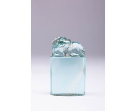 A CHINESE PALE TURQUOISE GLASS SEAL QING DYNASTY The finial formed as a recumbent qilin, raised on a tall oval plinth, the se