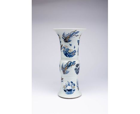 A CHINESE UNDERGLAZE BLUE AND COPPER-RED 'PHOENIX' BEAKER VASE, GU KANGXI 1662-1722 Decorated with eight moulded medallions o