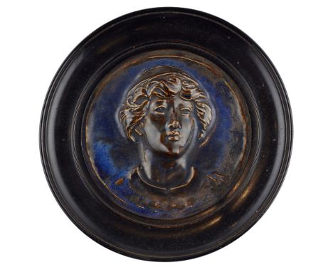 W* R*GOTHIC REVIVAL POTTERY ROUNDEL, CIRCA 1880 modelled in relief as a portrait of a young man, covered in a brown and blue 