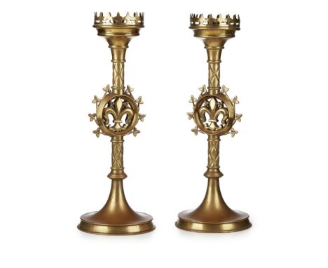 AFTER AUGUSTUS WELBY NORTHMORE PUGIN (1812-1852)PAIR OF GOTHIC REVIVAL BRASS ALTAR CANDLESTICKS, CIRCA 1850 each with fleur-d