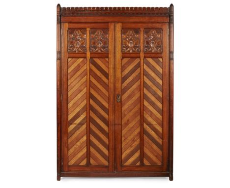 CHRISTOPHER DRESSER (1834-1904)AESTHETIC MOVEMENT OAK TWO-DOOR WARDROBE, CIRCA 1880 the castellated cornice above twin doors 
