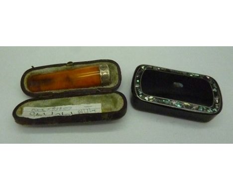 A silver mounted amber cigarette holder, with case and a mother of pearl inlaid snuff box