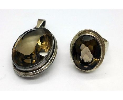 A silver and smoky quartz pendant and a silver and a smoky quartz ring, size R