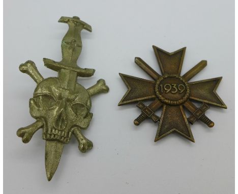 A WWII German Waffen SS skull and cross bones dagger badge and a German 1939 Cross