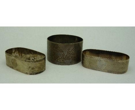 A pair of silver napkin rings and one other silver napkin ring, weight 53.2g