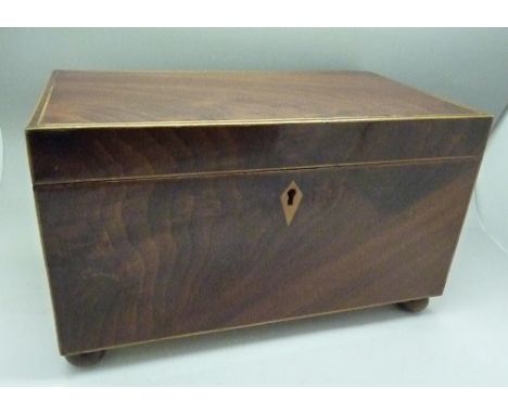 A Georgian flame mahogany inlaid two compartment tea caddy with key, width 26cm