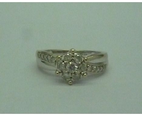 A 9ct white gold diamond cluster ring, stamped 0.50 to the shank, weight 3.8g, size O