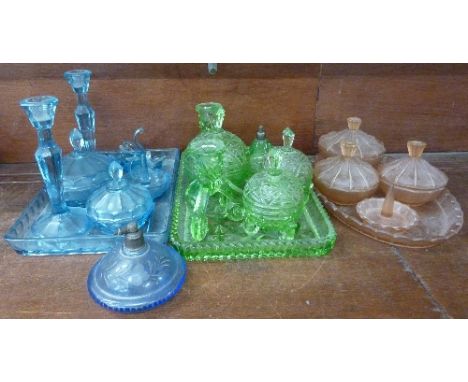 Three glass Art Deco dressing table sets, blue, peach and green