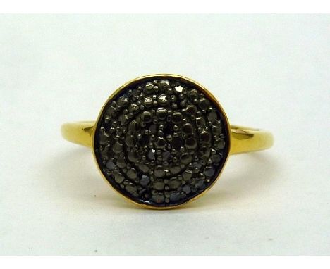 A silver gilt ring set with eighteen black diamonds, size O