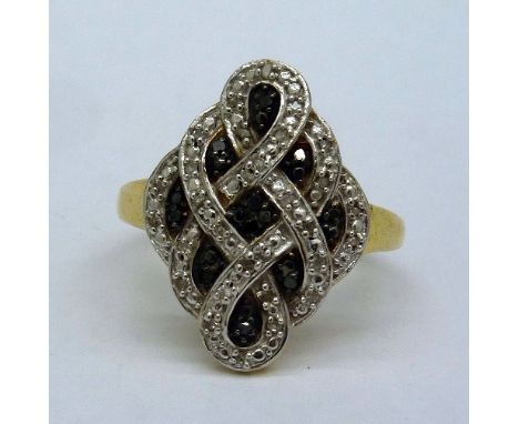 A Celtic style silver gilt ring set with forty-two black and white diamonds, size W