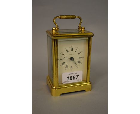 Asprey gilt brass carriage clock, the enamel dial with Roman and Arabic numerals 