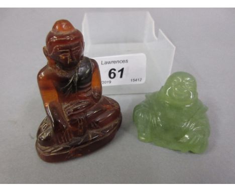 Carved amber figure of Buddha (at fault), together with a carved jade figure of Buddha 