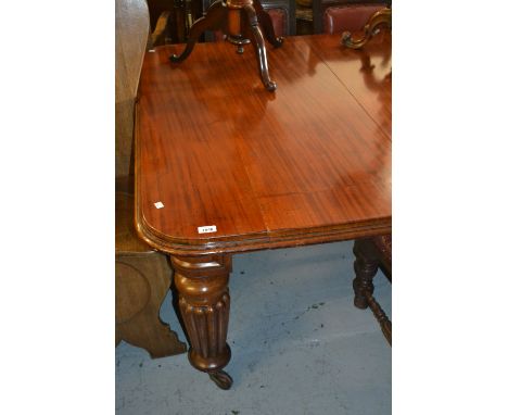 William IV mahogany rectangular wind-out extending dining table with a moulded top raised on turned fluted tapering supports,