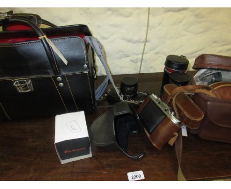 Praktica SLR camera outfit including various lenses, booklets and accessories in a simulated leather camera bag, cased Agfa I