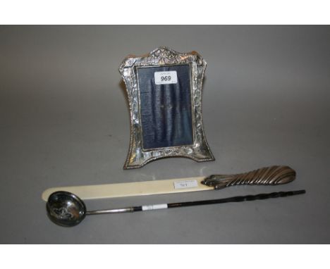 Silver mounted photograph frame (at fault), silver mounted ivory page turner and an antique white metal toddy ladle with whal