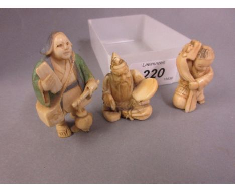 Japanese Meiji period netsuke in the form of a seated boy with a dragon costume, another of a seated figure holding a disc an