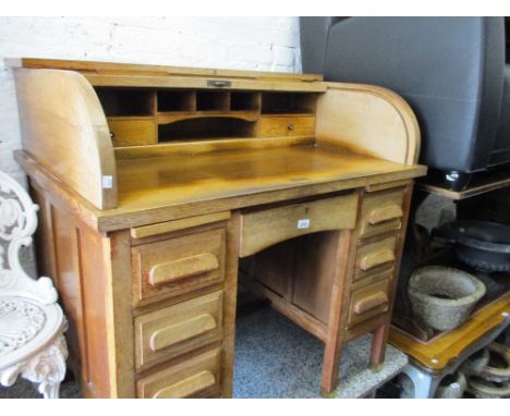 Early 20th Century oak roll-top desk, the D-shaped tambour above seven drawers on square cut supports 