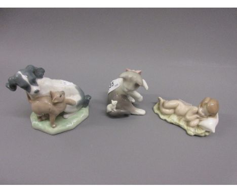 Lladro figure of a sleeping child, Lladro figure of a cat with a mouse and a Nao figure of a cat and a dog 