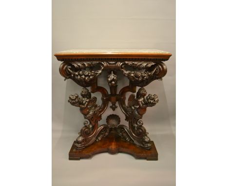 19th Century Italian walnut console table having grey flecked marble top, above a heavily carved frieze on shaped shell dolph