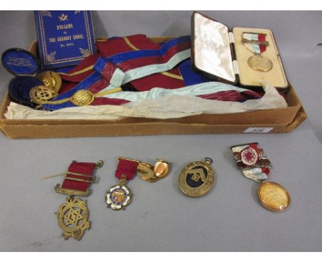 Group of seven various silver gilt and 9ct gold mounted Masonic medals with ribbons, in leather case containing original sash