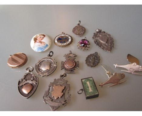 Pair of helicopter motif cufflinks, quantity of silver fobs, gold back and front locket and a circular porcelain portrait pla