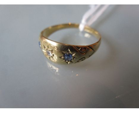 18ct Gold three stone diamond and sapphire set ring in gypsy type setting 