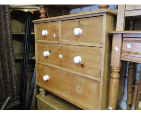 Small stripped pine chest of two short and two long drawers with ceramic knob handles 
