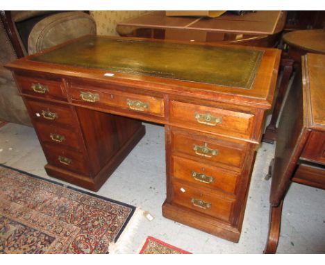 Small Edwardian mahogany twin pedestal desk with a green tooled leather inset top above nine drawers, raised on plinth bases 