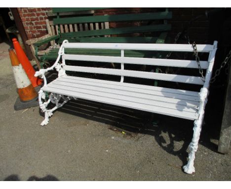 Victorian style garden bench with two matching armchairs, the white painted cast metal dog's head and serpent supports entwin