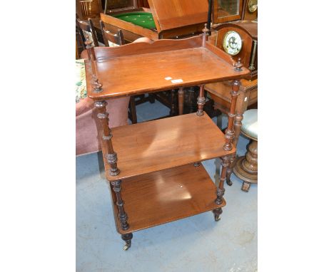 19th Century mahogany three tier whatnot having galleried top and turned supports with brass and ceramic casters 