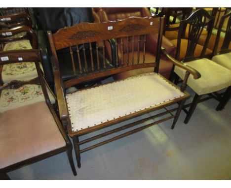 20th Century oak two seat bench having carved spindle back raised on turned supports 