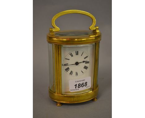 20th Century French oval brass cased carriage clock having enamel dial with Roman numerals (at fault), on low supports, 5ins 