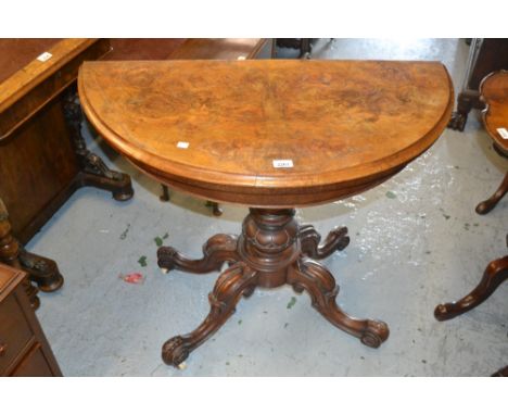 Victorian burr walnut demi lune fold-over card table on turned single column with cabriole carved supports, having brass and 