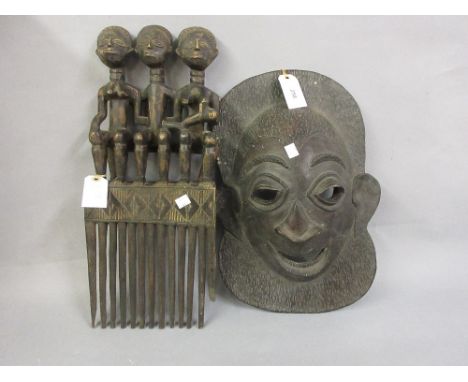 African native carved comb together with a native carved wall mask 