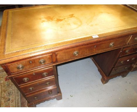 19th or early 20th Century mahogany twin pedestal desk with a green leather inset top above nine drawers with circular brass 