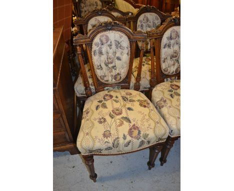 19th Century walnut drawing room suite of 'his' and 'her' chairs and four matching side chairs, having carved and button upho