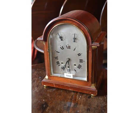 Edwardian mahogany dome shaped mantel clock with silvered dial having Roman numerals, subsidiary chime, slow / fast and three