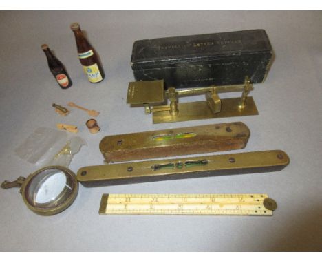 S. Mordan and Co. cased gilt brass travelling letter scale, together with an ivory folding ruler, two small spirit levels and