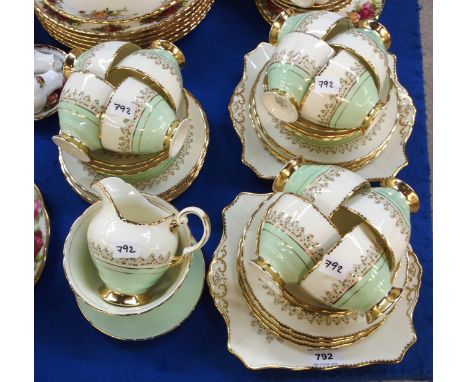 A Plant Tuscan teaset, the cream and green banded ground with enamel decoration comprising two cake plates, twelve side plate